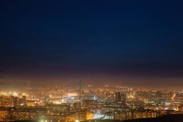 Night view of the Siberian city in winter. Krasnoyarsk, Russia. Air pollution.