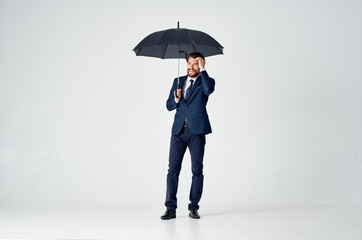 business man in a suit holding an umbrella elegant style rain protection