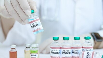 Close-up, doctor's hand and bottle of covid-19 vaccine covid 19 concept