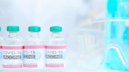 Three vaccine bottles are placed on the doctor's desk. covid 19 concept