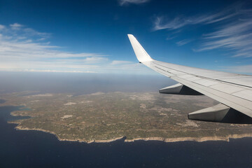 Fototapeta na wymiar Panoramic view of whole Malta with an airplane wing, stormy Mediterranean Sea