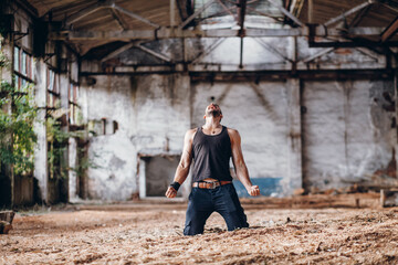 Young Strong but Broken Man Crying in Despair on his Knees