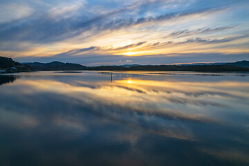 Sunrise and cloud reflections waterscape
