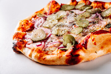 pizza with Mozzarella cheese, ham, tomato sauce, pepper, pickled cucumbers and onion. Italian pizza