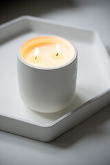Fototapeta na wymiar Burning candle with two wicks, handmade candle in white jar