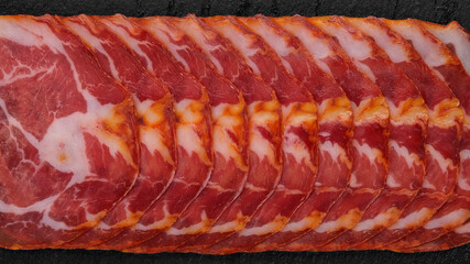 Sliced Spanish sausages Coppa or Capicola top view