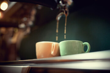 Cup of coffee on coffee maker machine.