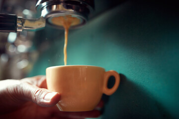 coffee pouring into cup.Close up