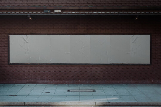 Urban Mock up white paper billboard or poster in a frame on a wall background
