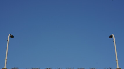 The city highway lamps view with the clear blue sky as background