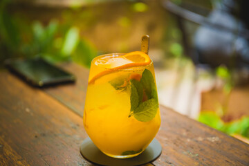 A closed up shot of a orange and mango mocktail served at a hipster cafe at Malacca, Malaysia.