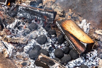 BBQ Grill Pit With Glowing And Flaming Hot Charcoal. Glowing Hot Charcoal In Barbecue Grill Pit With Flames Background Texture, Close-up