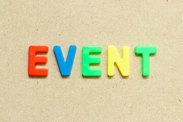 Color alphabet letter with word event on wood background