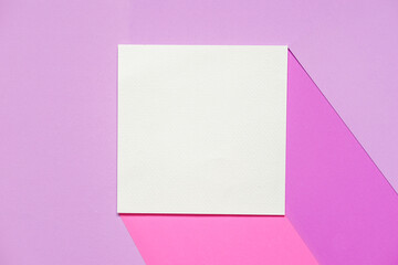 Obraz na płótnie Canvas Identity mockup card concept with a blank white brochure on pink and violet color paper against a pastel purple paper background.