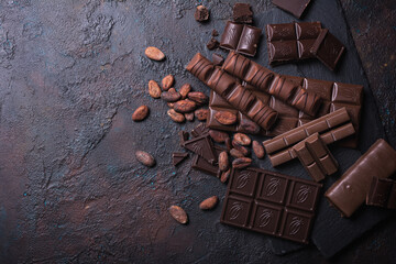 Chocolate background with lots of bars and cocoa beans