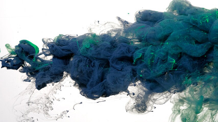 Drops of dark blue and green ink in water. Colored acrylic paints in water. Gray-blue and green...