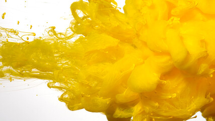 Yellow cloud of ink on a white background. Awesome abstract background. Drops of yellow ink in...