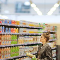 supermarket shopping,Woman choosing a dairy products at supermarket.