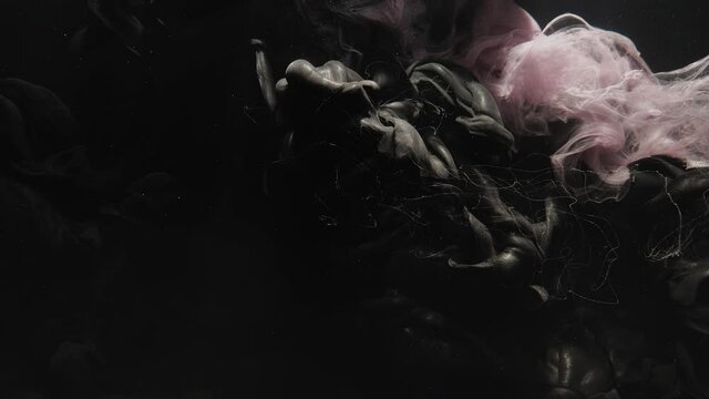 Paint water mix. Logo reveal. Color smog cloud. Underwater fluid explosion animation. Pink black fume flow motion on dark glitter dust particles abstract background for title.