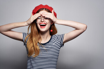 cheerful woman wearing a red hat makeup fashion posing