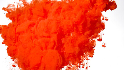 Red-orange watercolor ink in water on a white background. Beautiful abstract background. Red-orange acrylic paints are mixed in water.