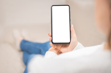 Mockup cellphone. blank white screen smartphone.woman hand holding texting using mobile on sofa at home office.background empty space for advertise text. people contact marketing business, cell phone