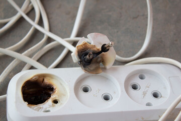 the plug and socket burned melted short circuit - obrazy, fototapety, plakaty