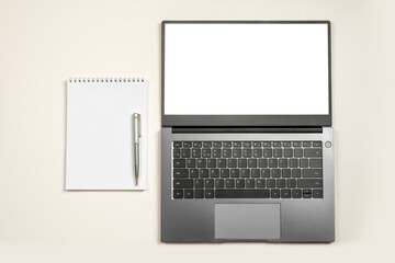 Minimal workplace mockup with laptop and blank notepad on white isolated background. Top view. Flat lay laptop with blank screen or mock up computer