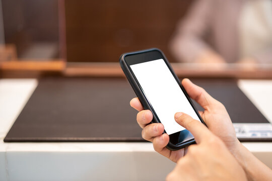Empty smartphone screen isolated with clipping path. Unrecognizable Asian young businesswoman using a smartphone.