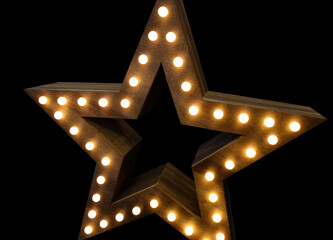 Wooden star with lights on black background