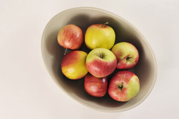 ripe red and green apples in a deep dish