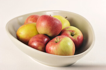 ripe red and green apples in a deep dish