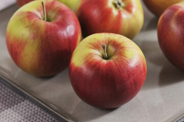 red ripe apples on a plate -