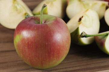 red ripe apple and apples cut into slices