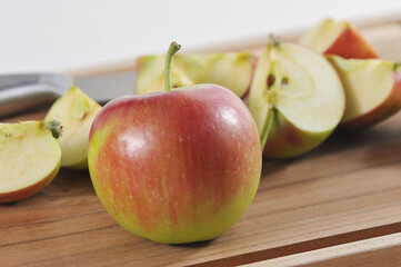 red ripe apple and apples cut into slices
