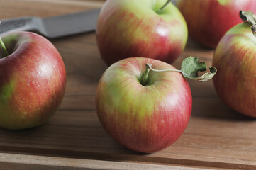 red ripe apples on a wooden board