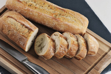 small French baguette on a wooden board