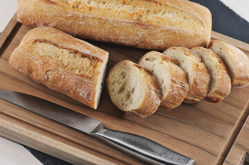 small French baguette on a wooden board