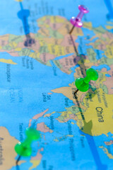Location Pin on India on a World Map. Global Mapping. Close up. Vertical. Table top view. Selective focus. Shallow depth of field.