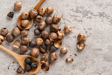 Fermented black garlic. The color is a result of the Maillard reaction or caramelization. Black garlic can help to regulate blood sugar levels. negative space. selective focus.