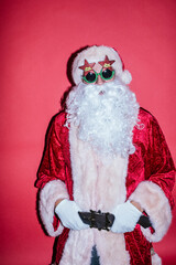 Man dressed as Santa Claus gesturing with funny glasses