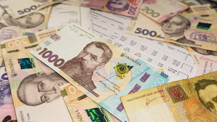 Obraz na płótnie Canvas Ukrainian money hryvnia and coins penny wooden background, utility bill.