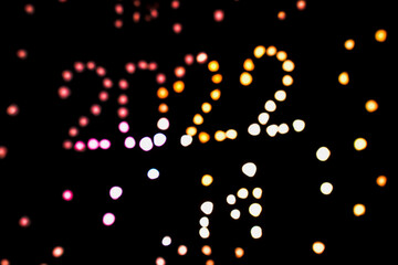 2022 happy new year. composition with blur lights and dark background. celebration mood.