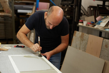 book binder working in a workshop