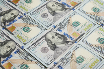 A pile of one hundred American dollars bills, close-up