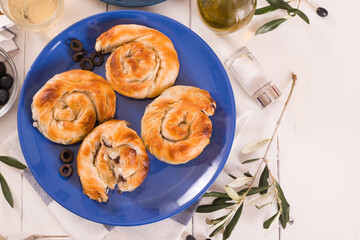 Pastry swirls with cheese and olive filling.