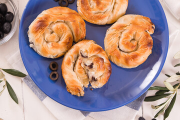 Pastry swirls with cheese and olive filling.