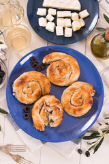 Pastry swirls with cheese and olive filling.
