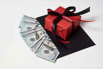 Gift box with dollar banknotes on white background
