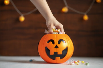trick or treat,Happy Halloween,hand takes candy pumpkin lollipops for children at a party